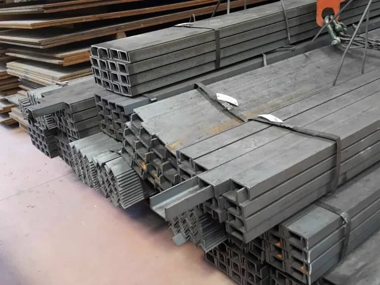 Steel merchant bars and hollow structural profiles stacked in an industrial warehouse